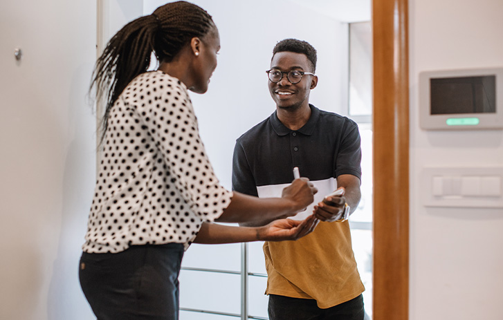 A volunteer speaks with a voter at the door